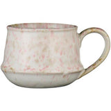 Speckled ceramic mug on a white background