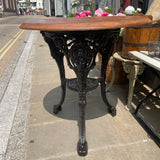Vintage round garden table with cast iron base. Side view