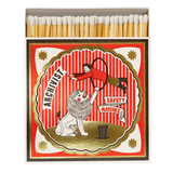 A vintage-style matchbox with wooden matches visible at the top and a illustrated front label reading 'ARCHIVIST' and 'SAFETY MATCHES.' The label shows a red-and-white striped circus scene with a lion and a person in a red outfit.