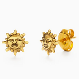 Gold sun-shaped earrings on a white background