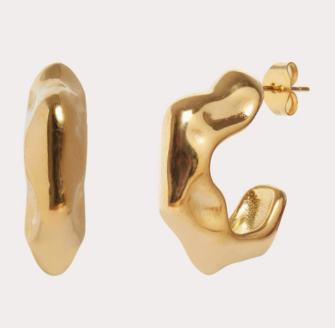 Gold hoop earrings on a light gray background