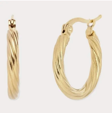 Gold hoop earrings on a light gray background