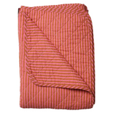 A folded quilted blanket with a vertical stripe pattern in coral pink and white, shown against a plain white background.