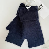 Pair of navy blue fingerless gloves with a visible brand tag on a light background