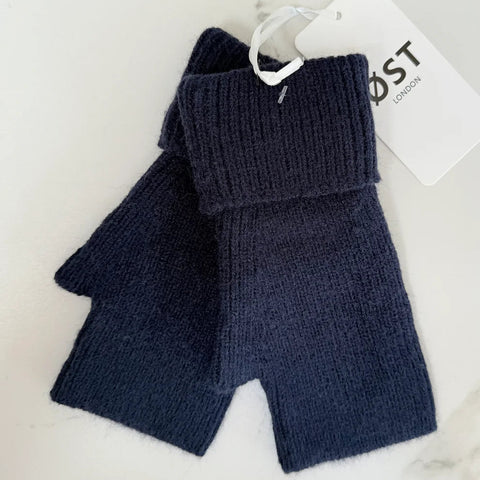 Pair of navy blue fingerless gloves with a visible brand tag on a light background