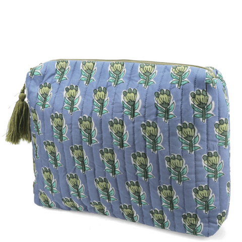 Blue quilted wash bag with green floral pattern on a white background