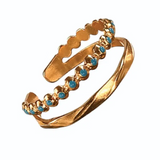Gold ring with turquoise stones on a white background
