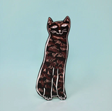 A tall, black leather bookmark in the shape of a cat, with a simple, stylized design.