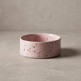 Pink terrazzo-patterned bowl on a beige background