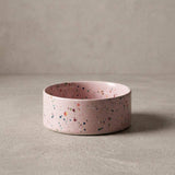 Pink terrazzo-patterned bowl on a beige background