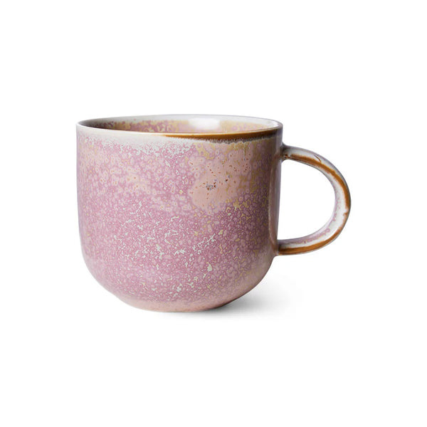 Pink ceramic mug with speckled texture on a white background