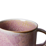 Close-up of a ceramic mug with speckled design on a white background