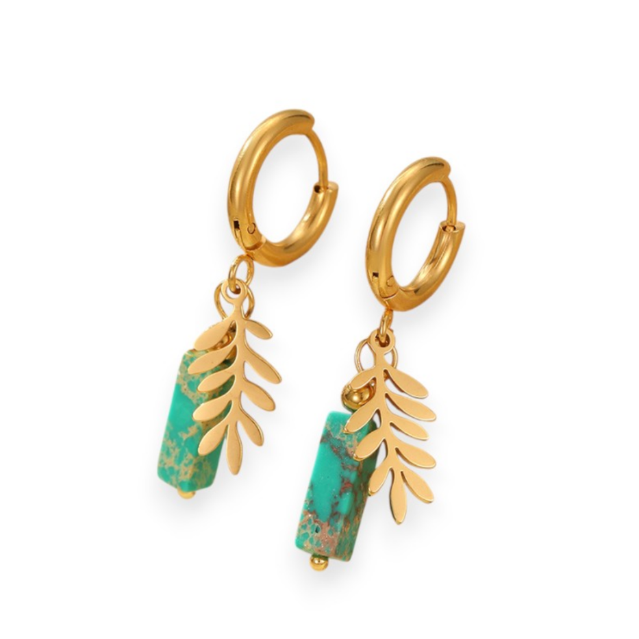 Gold hoop earrings with green stone drops on a white background