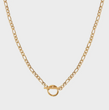 Gold chain necklace on a light gray background