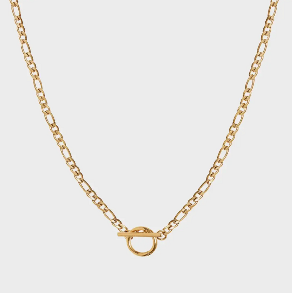 Gold chain necklace on a light gray background