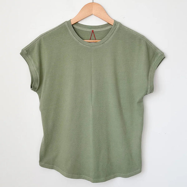 Green t-shirt on a wooden hanger against a white background