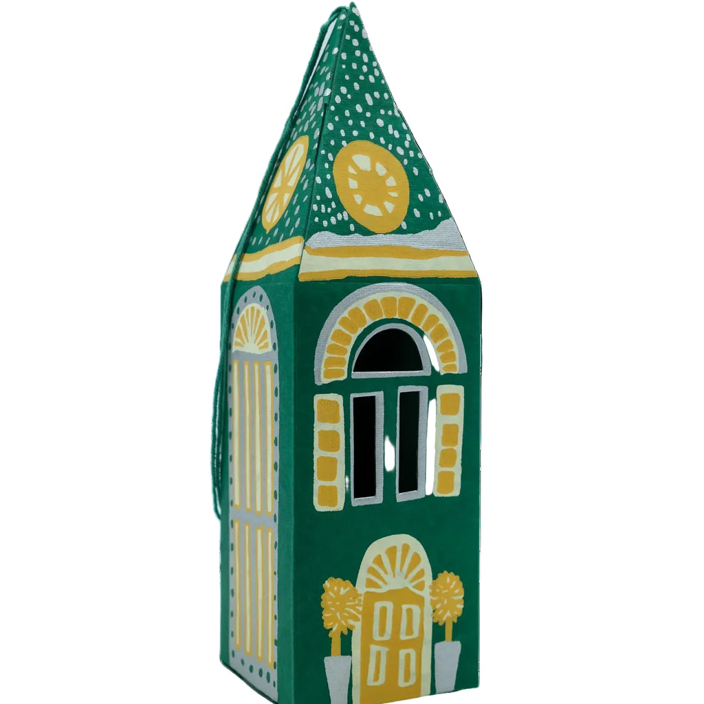 A small hand-painted house-shaped box or container in dark green with yellow, white, and black decorative details, shown on a plain white background.