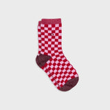 A single crew sock with a red and pink checkerboard pattern, featuring solid dark red heels, toes, and cuffs, shown against a light gray background.