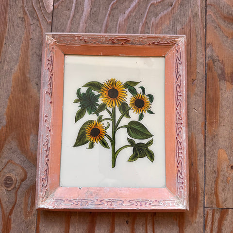 files/Framed_embroidered_artwork_of_sunflowers_on_a_wooden_surface.jpg