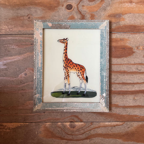 files/Framed_illustration_of_a_giraffe_on_a_wooden_surface.heic
