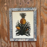 Framed illustration of a pineapple on a wooden background