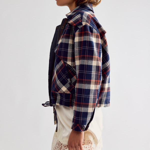 Free People Morant Jacket in Navy. A woman shown in side profile wearing a cropped, oversized plaid flannel shirt jacket in navy, red, and cream,