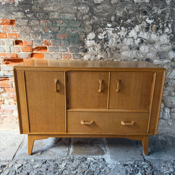 Wooden sideboard against a stone wall