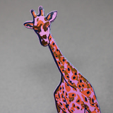 A hot pink and orange giraffe-shaped leather bookmark with spotted patterns.