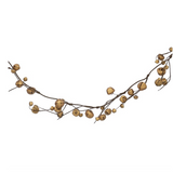 Gisela Graham Gold Bells Twig garland. A rustic decorative garland made of small natural wood beads strung on a dark brown twig, photographed against a plain white background.