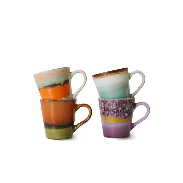 Four colorful ceramic mugs stacked in two pairs on a clean white background. The mugs feature abstract, multi-colored glazes with swirls and bands of orange, purple, teal, green, brown, and cream.