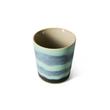 Ceramic cup with striped design on a white background