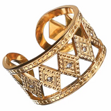 Gold ring with intricate design on a white background