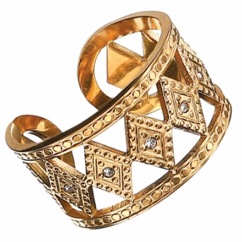 Gold ring with intricate design on a white background