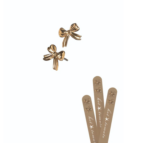 Gold bow-shaped earrings on a white background