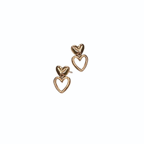 Heart-shaped gold earrings on a white background