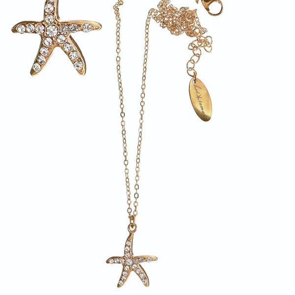 Gold starfish necklace with a pendant on a white background
