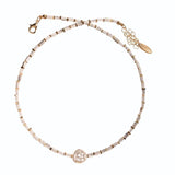 Beaded bracelet with a rose gold clasp on a white background
