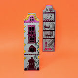 Decorative bookends shaped like houses on an orange background