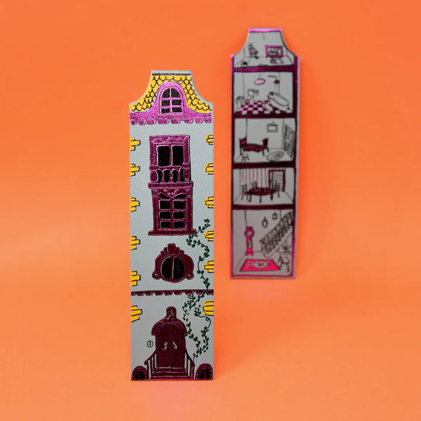 Decorative bookends shaped like houses on an orange background