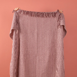 Ian Snow Plum & Dusty Rose Recycled Cotton Striped Throw held up