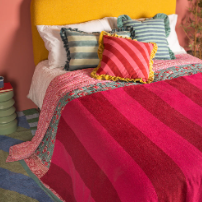 files/Ian_Snow_Red_Pink_Recycled_Cotton_Wide_Stripe_Throw_side_view_on_bed.png