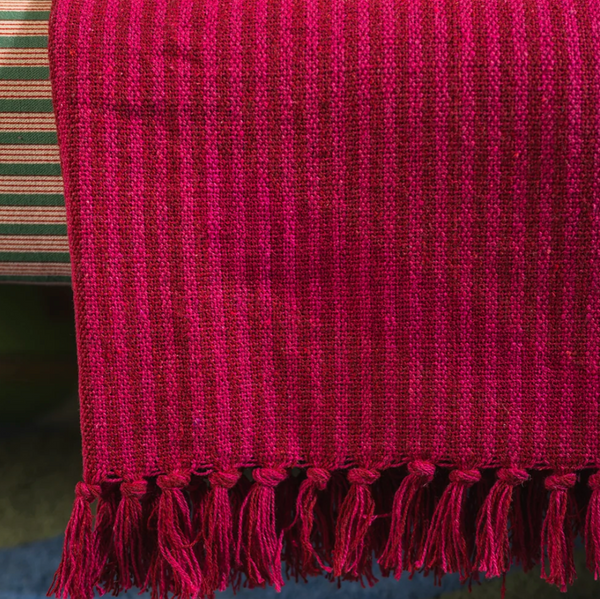 Ian Snow Red and Pink Recycled Cotton Striped Throw draped