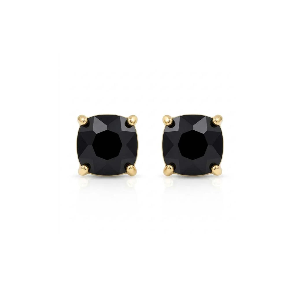 Pair of ruby and diamond earrings on a white background