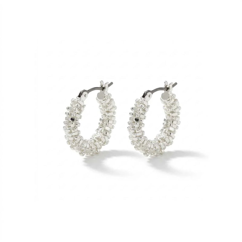 A pair of silver hoop earrings adorned with clear, faceted crystal-like beads, displayed on a clean white background with soft shadows.