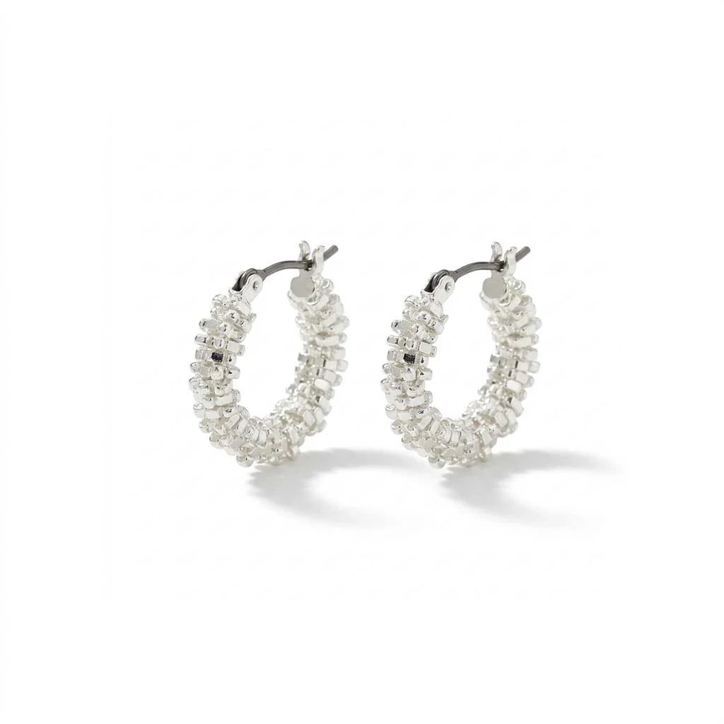 A pair of silver hoop earrings adorned with clear, faceted crystal-like beads, displayed on a clean white background with soft shadows.