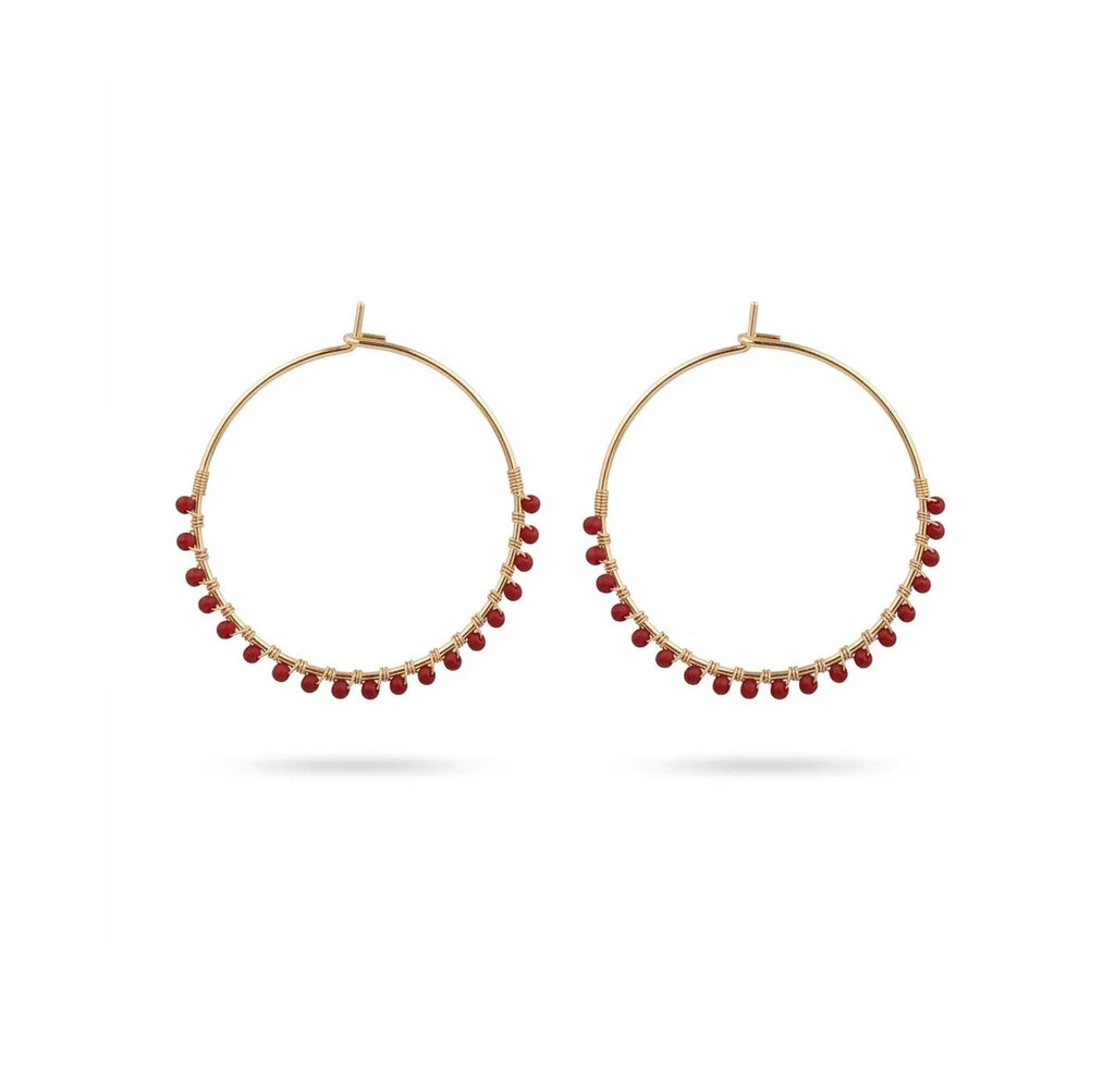 A pair of gold hoop earrings with small red bead accents along the lower curve, displayed against a clean white background.