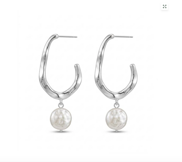 A pair of silver-toned abstract hoop earrings with dangling textured white freshwater pearls, shown on a plain white background.