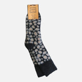 A single fuzzy knit sock with an animal print pattern in beige and white, attached to a tan paper hanger that reads 'Jess & Lou Animal Print Socks', shown against a plain light gray background.