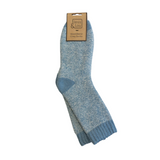 A pair of light blue and white heathered knit socks with a solid blue heel and toe, hanging from a brown paper tag that reads 'Jess & Lou'.