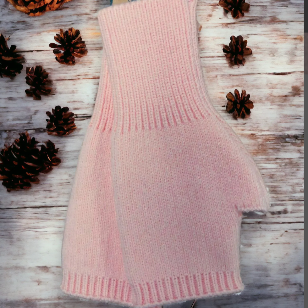 Jess and Lou pink plain knit fingerless gloves on wooden background 
